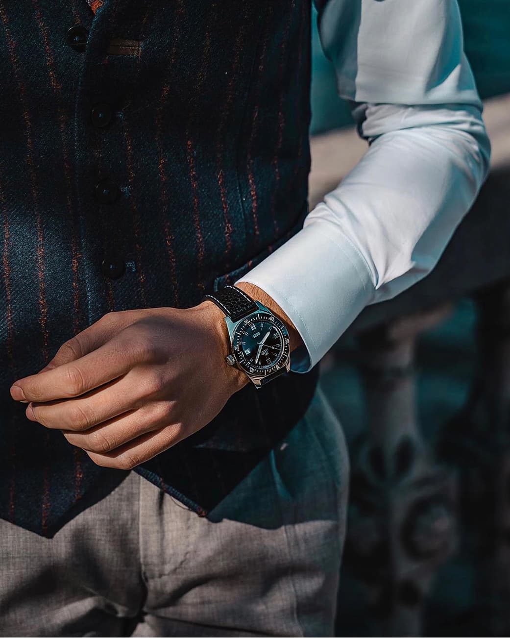 A person wearing a 1972 Eza watch with tailoring